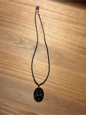 Black Oval Pendant Necklace with Floral Motif